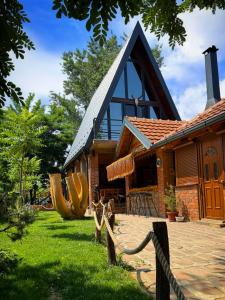 a house with a fence in front of it at Beaver lodge - Dabrova Koliba in Bijeljina