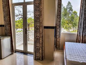 a room with a glass door with a window at Motel Bờ Kè in Bà Rịa