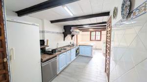 a kitchen with blue cabinets and blue counters at Villa Mona Private pool and barbecue in Malaga in Málaga