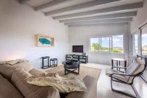 a living room with a couch and chairs and a tv at Casa di Mama Villa with Private Pool in Jan Thiel +47 photos