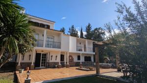 a large white house with a courtyard at Villa Mona Private pool and barbecue in Malaga in Málaga