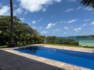 a swimming pool with a view of the ocean at Lorlagon 2-Bedroom Beachfront Apartment by LOV Mauritius in Trou d'Eau Douce