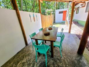 ein Holztisch und Stühle auf einer Terrasse in der Unterkunft Casa Recanto ViVaMar - 3 bedroom house, 10 min from the beach in Barra Grande + 44 Fotos