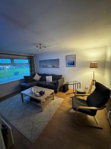 a living room with a couch and a table at Central 2 bed Apartment Bangor in Groomsport