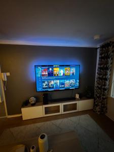 a living room with a flat screen tv on a wall at Central 2 bed Apartment Bangor in Groomsport +1 photo