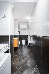 a bathroom with a sink and a toilet in it at Gramsci Prestige Apartment in Bologna +43 photos