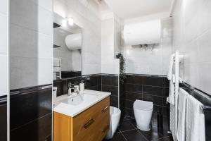 a bathroom with a sink and a toilet at Gramsci Prestige Apartment in Bologna