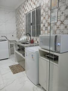Kuchyň nebo kuchyňský kout v ubytování Flat Bastos Residence