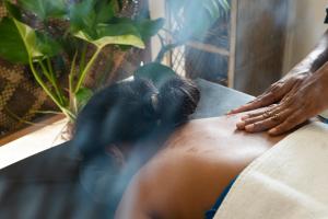 a man getting a massage on his back at Parasol dore in Dickwella