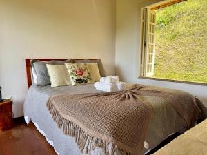 Ένα ή περισσότερα κρεβάτια σε δωμάτιο στο Chalé com área gourmet privativa +35 φωτογραφίες