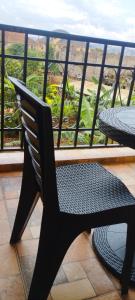 a black chair sitting on top of a balcony at Serenity in Kampala