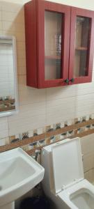 a bathroom with a white toilet and a sink at Serenity in Kampala