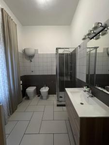 a bathroom with a toilet and a sink and a shower at A casa di Rita in Agropoli +25 photos