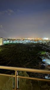 a view of a parking lot with a city in the background at Italian design et Vue panoramique in El Aouina Station +9 photos