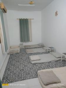 a room with four mattresses on the floor at Home of turtles in Al Ḩadd +14 photos
