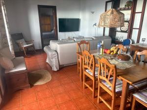 a living room with a table and chairs and a bed at Casa Pardelo in Fuencaliente de la Palma