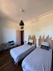 ein Schlafzimmer mit zwei Betten, einem Tisch und einer Lampe in der Unterkunft La gare de Chambretaud in Chambretaud