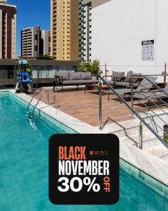 a swimming pool with a sign that reads black november at Simple Smart By Xtay - Novo, aconchegante e a 7min do Manaíra Shopping in João Pessoa