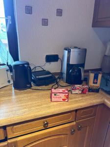 a kitchen counter top with a coffee maker and a coffee pot at Ferienwohnung Jägerhaus in Walldürn