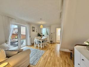 a living room with a couch and a table at SubLyme in Lyme Regis