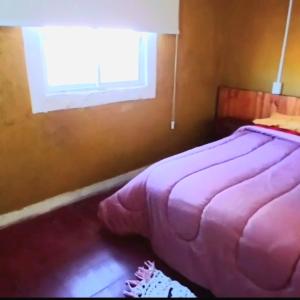 Postel nebo postele na pokoji v ubytování Hospedaje La Casona de los Paredones