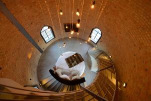 Una escalera de caracol con una cama en una habitación en Wasserturm Bad Saarow, en Bad Saarow