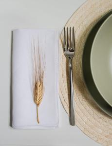 a fork on a napkin next to a plate at Viridiano Rooms & Apartments in Sciacca +34 photos