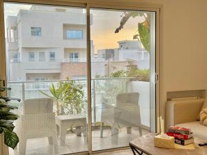 a living room with a sliding glass door to a balcony at Residence The Green in Tunis