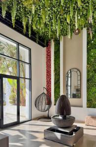a lobby with a large fountain and a large window at Residence The Green in Tunis