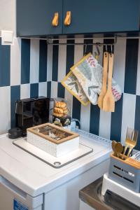 a kitchen with blue and white striped walls at City Central Apartment with Parking in Larisa +16 photos