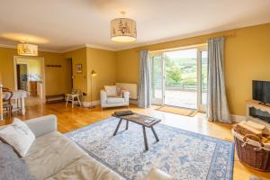 a living room with a couch and a table at Waun Yscir Rural escape in the Brecon Beacons in Brecon