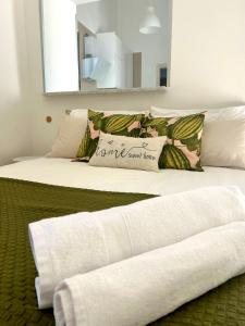 two beds with towels on them in a room at Sweet Home in Vico Equense