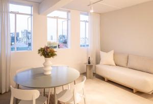 a living room with a table and a couch at BlackBrick Gardens in Cape Town
