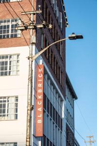 a street light with a sign on the side of a building at BlackBrick Gardens in Cape Town