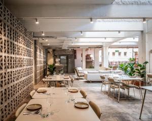 a dining room with tables and chairs and a couch at BlackBrick Gardens in Cape Town +59 photos
