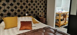 a bedroom with a bed with yellow and orange pillows at Carpe Diem in Saint-Savin-sur-Gartempe