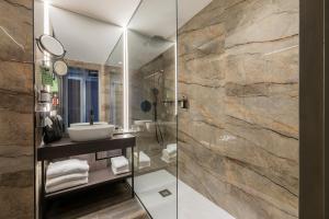 a bathroom with a sink and a glass shower at HF Ipanema Porto in Porto