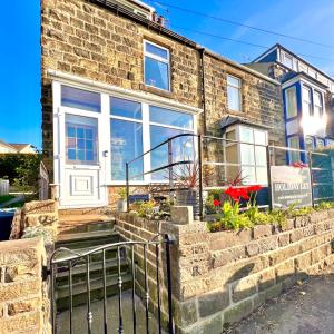 a brick house with a staircase in front of it at Wharfe View Cottage Ilkley in Ilkley