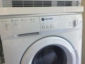 a white washing machine with a air conditioner at The Retreat with Free Parking in Ambleside