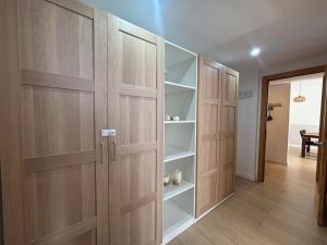 a room with wooden doors and shelves at Apartamento Clotilde Lloret in Lloret de Mar +32 photos