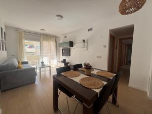 a living room with a table and a couch at Apartamento Clotilde Lloret in Lloret de Mar
