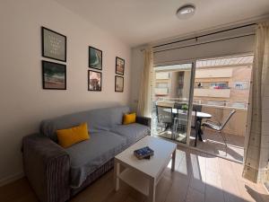 a living room with a couch and a table at Apartamento Clotilde Lloret in Lloret de Mar