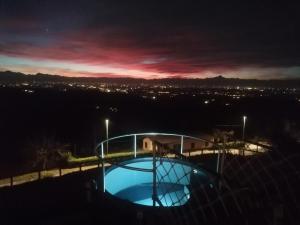 a night view of a swimming pool at night at Villa Belvedere Langhe in Belvedere Langhe