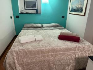 a bed with two pillows on it in a room at Angelo Home in Genova