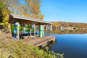 a small dock on a body of water at Dock Holiday - Hot Tub - Private Dock in Bella Vista +43 photos