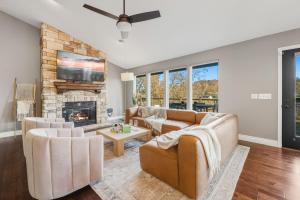 a living room with a couch and a fireplace at Dock Holiday - Hot Tub - Private Dock in Bella Vista
