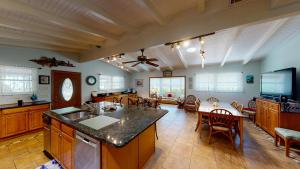 a large kitchen with a table and a tv at Barronhaus in Jekyll Island