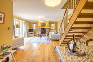 a living room with yellow walls and a staircase at Waun Yscir Rural escape in the Brecon Beacons in Brecon