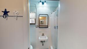 a bathroom with a sink and a mirror at Barronhaus in Jekyll Island +13 photos