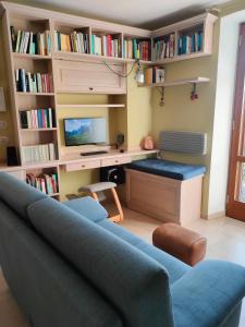 a living room with a blue couch and a desk at Ciliano 16 in Montepulciano +70 photos